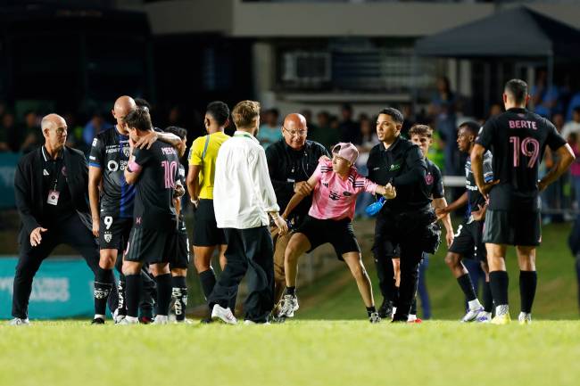 BAYAMON, PUERTO RICO - FEBRUARY 26: A kid is detained by security guards after jumping onto the field to greet Lionel Messi during a friendly game between Independiente del Valle and Inter Miami at Juan Ramón Loubriel stadium on February 26, 2026 in Bayamon, Puerto Rico. (Photo by Leopoldo Smith/Getty Images)